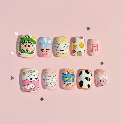 Kawaii anime press-on nails flat-lay on pastel pink surface